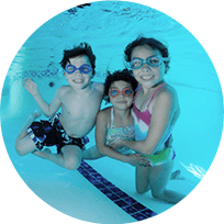 Three kids smiling underwater the swimming pool in circle crop photo